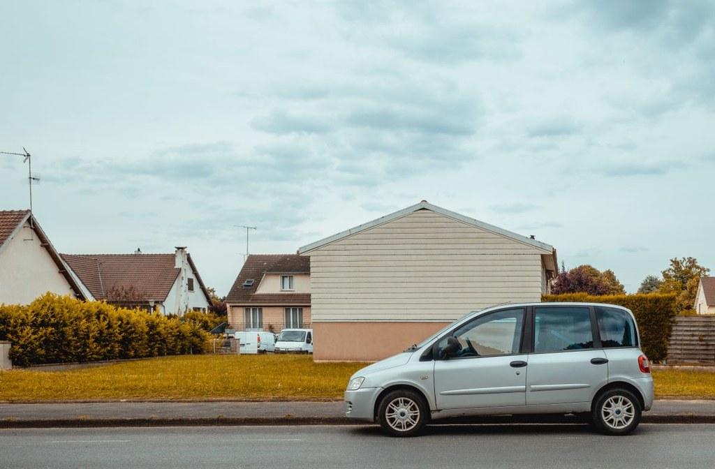 Listing exterior photo with a flat, overcast sky